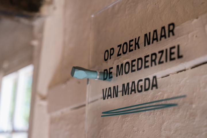 infobordje met tekst 'Op zoek naar de moederziel van Magda' in de expo Moederziel