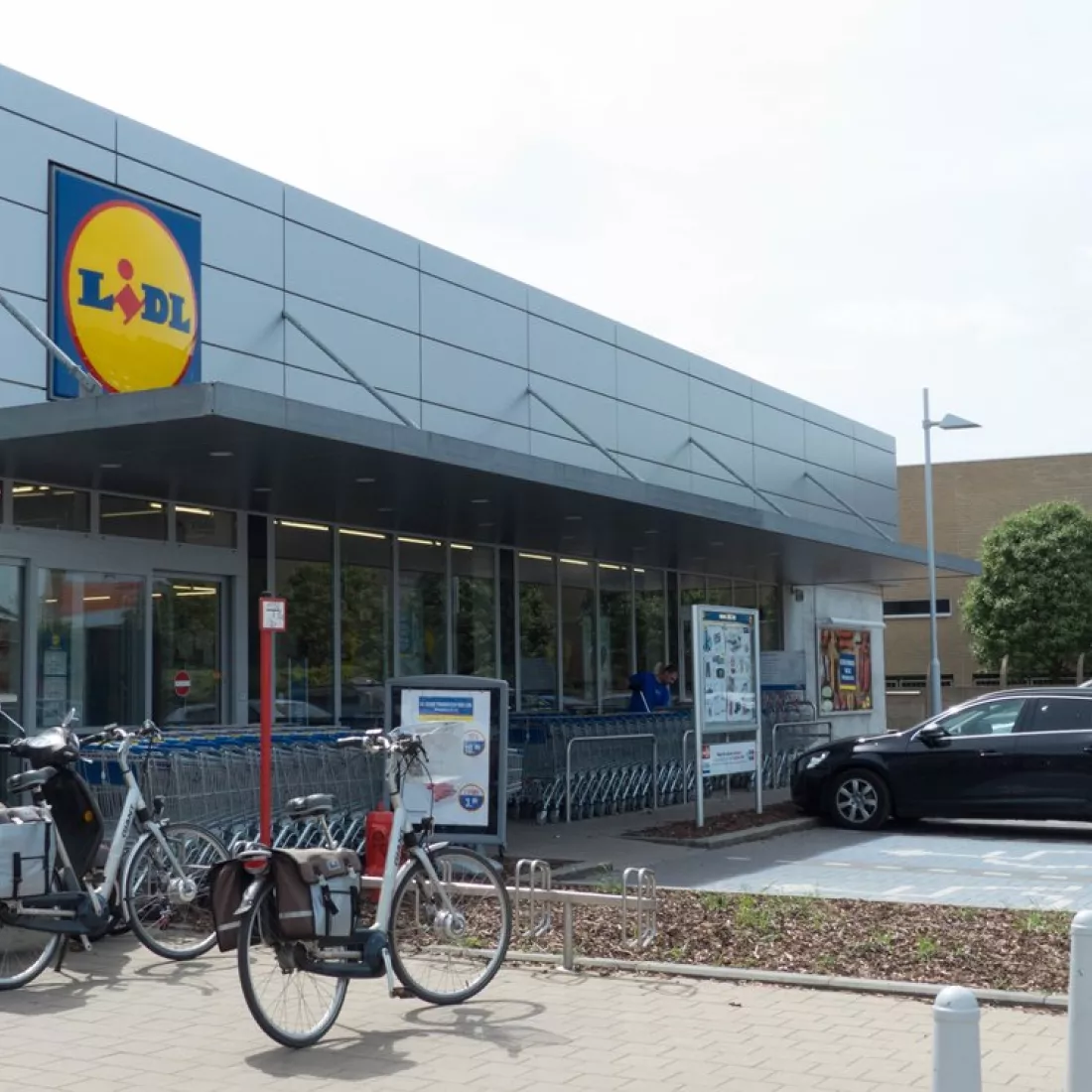 KMO Units Picolo - Van Ende: Lidl. Boven de inkom hangt het logo van Lidl. Er hangt een luifel over de winkelkarren. Voor de winkel zijn parkeerplaatsen voorzien.