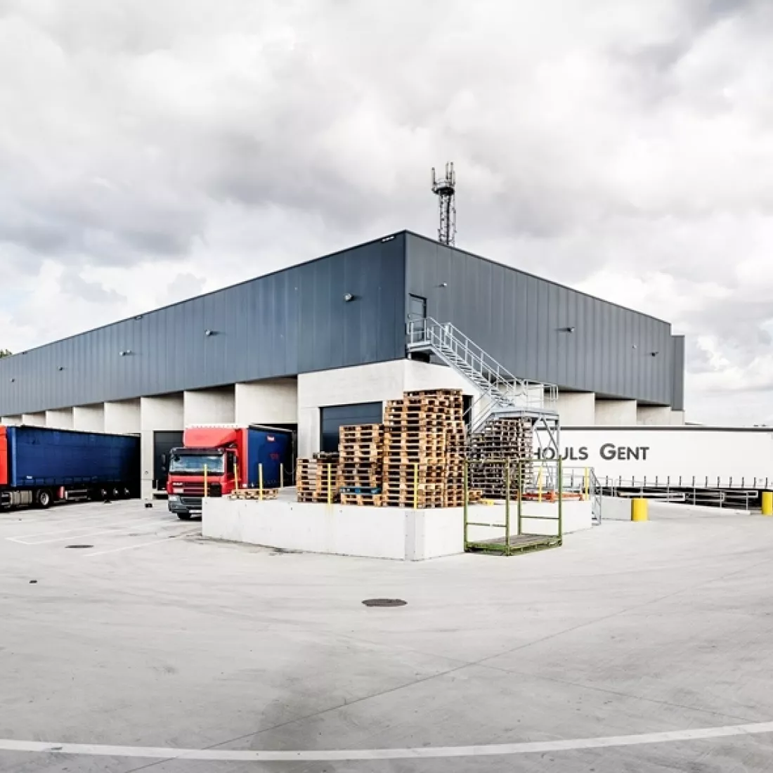 Zijaanzicht transitmagazijn Transuniverse. Langs beide kanten van het gebouw is er een dock voor het laden en lossen van vrachtwagens.