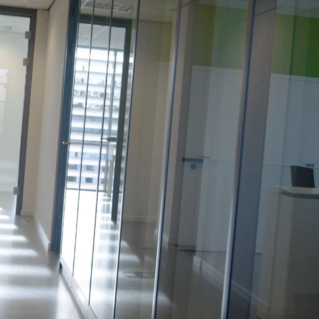 Binnenkant kantoor - DIBO. Deze afbeelding is gemaakt in de gang van een glazenwand.