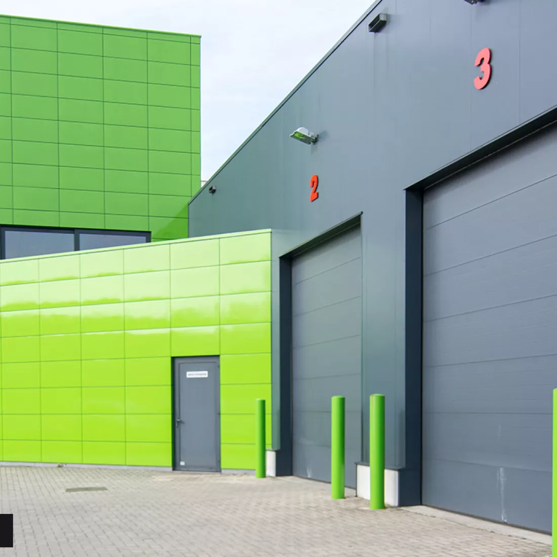 Zijaanzicht werkgebouw DIBO. Hierbij is de renovatie gebeurd en bestaat het gebouw uit groene tegels.