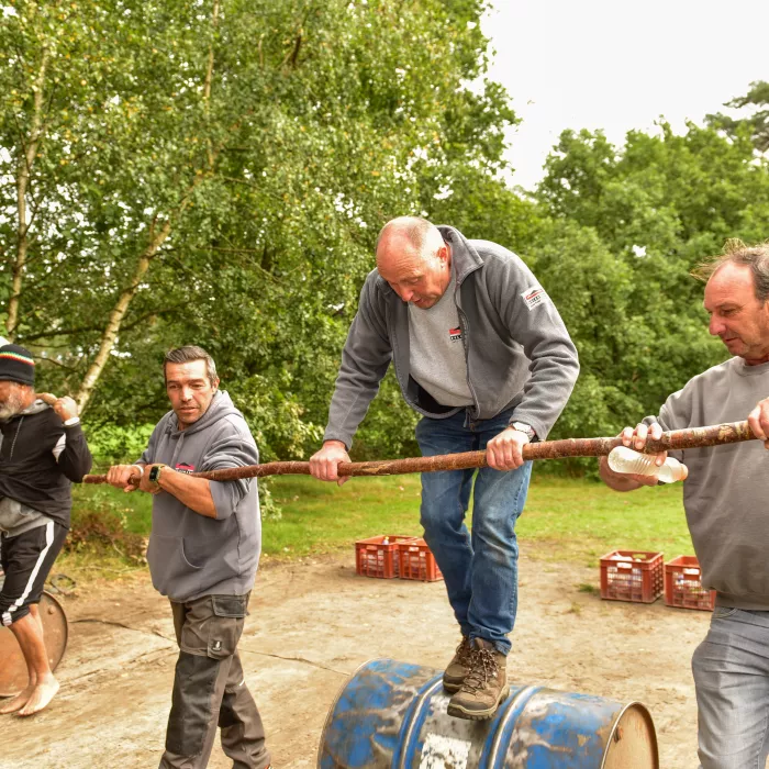 Een man die probeert op een ton te balanceren