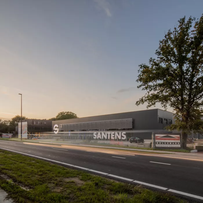 Zijaanzicht bedrijfsunit Immo Bolckmans Geelseweg. De foto is gemaakt vanaf de overkant van de weg. Het gebouw is zwart en gemaakt uit staal.