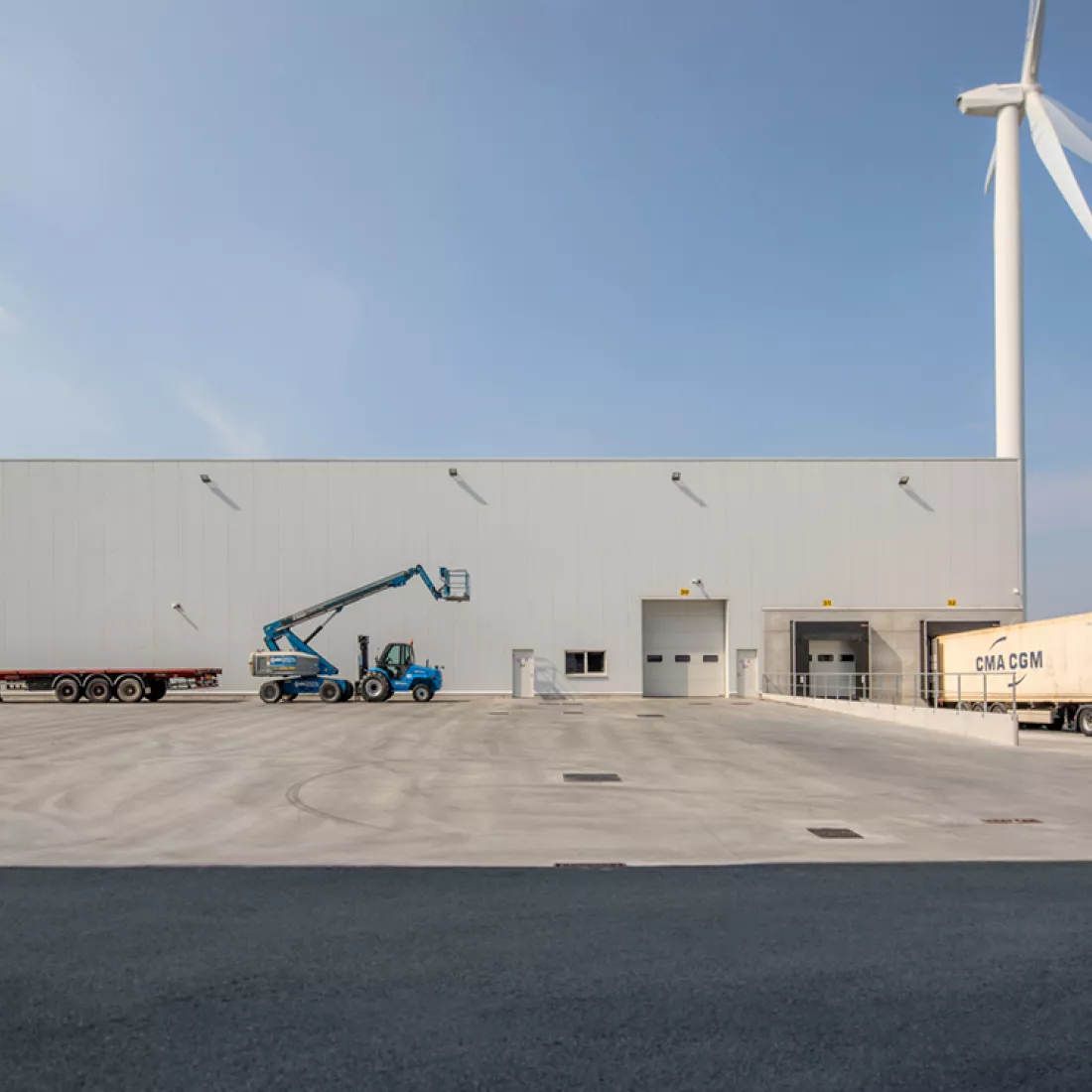 Citrosuco diepvriesloods. Het gebouw is wit en gebouwd met staal. Rechts bevindt zich een dock voor het laden en lossen van vrachtwagens. Rechtsachter het gebouw bevindt zich een witte windmolen.