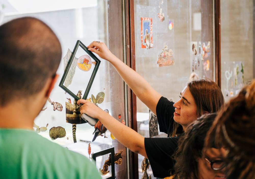 participants working on a collage on a big window